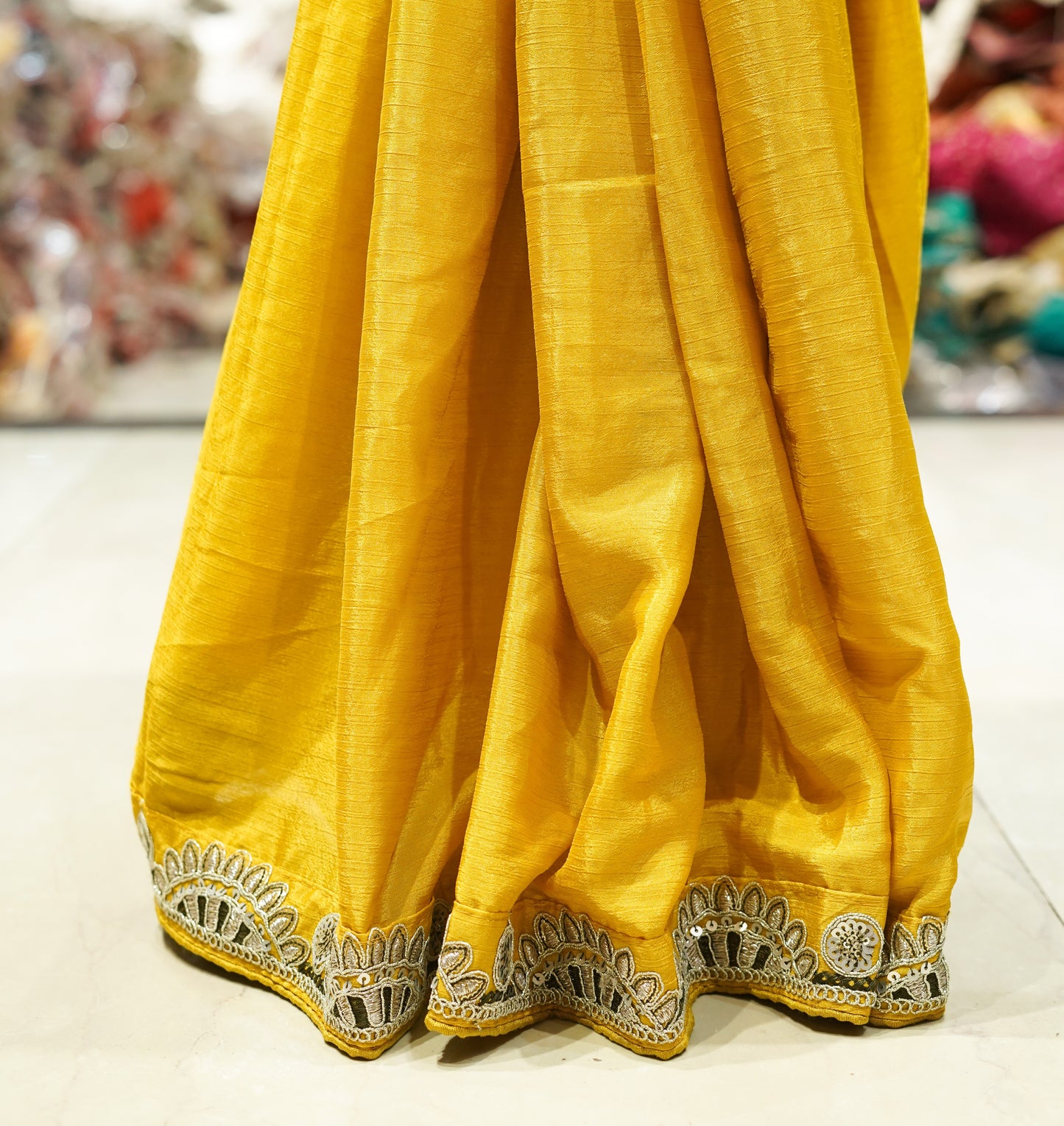 Yellow crepe saree with olive embroidery work and stitched blouse