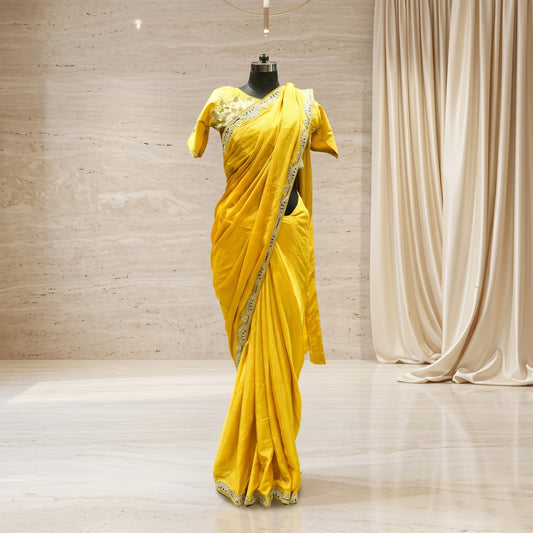 Yellow crepe saree with olive embroidery work and stitched blouse