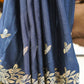 Blue fabric with gold floral patterns on a stand