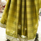 Green saree with white border on a mannequin in a store setting